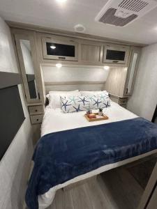 a bedroom with a large bed in an rv at The Lake Escape RV Meets The Beach in Foley +12 photos