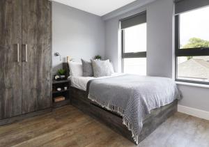 a bedroom with a bed and a large window at For Students Only - Collegiate Crown Place Cardiff in Cardiff