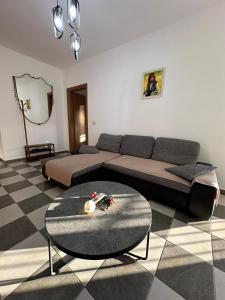 a living room with a couch and a table at Rocks View Apartment in Durrës +11 photos