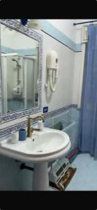 a bathroom with a white sink and a mirror at Casa Allegra Mondello in Palermo
