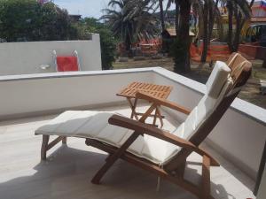a chair and a table on a roof at Golden River n1 Marina di Campo in Campo nell'Elba