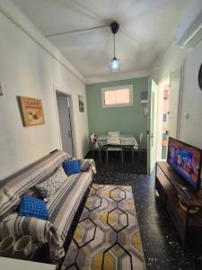 a living room with a couch and a flat screen tv at casa giustina in Ventimiglia