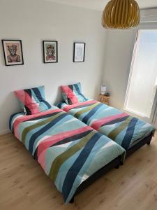 two beds sitting next to each other in a bedroom at Maison de vacances ossature bois 2-4 personnes- Saint Gilles Croix de Vie 85800 in Saint-Gilles-Croix-de-Vie +9 photos