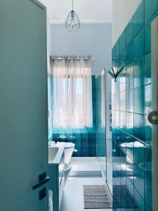 a bathroom with a tub and a toilet and a sink at Villa Lina in Castiglioncello