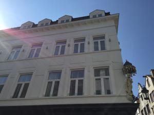a white building with windows on top of it at Antwerp Business Suites in Antwerp