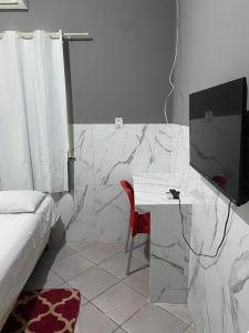 a bedroom with a bed and a desk with a television at Hotel e Pousada REQUINTTE in Parnaíba +12 photos