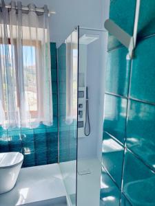 a bathroom with a toilet and a glass shower at Villa Lina in Castiglioncello
