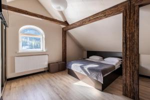 a bedroom with a bed and a large mirror at Marmaros Apart-Hotel & Spa in Bukovel +151 photos