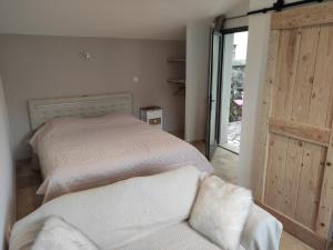 a bedroom with a bed and a sliding glass door at La croisée des destins in Viviers