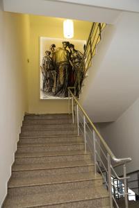 a painting on the wall next to a staircase at Hotel Ida in Kŭrdzhali