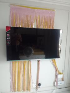 a flat screen tv hanging on a wall at Effile view studio apartment in Lahore