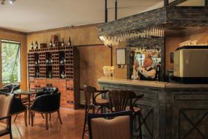 a bar with a man standing behind a mirror at Hotel Leonardo da Vinci in Santiago +39 photos