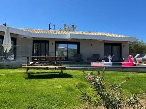 a house with a picnic table in the yard at Villa Danai in Gouvia