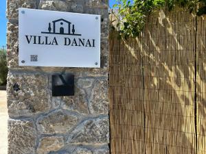 a sign for a villa dana on a stone wall at Villa Danai in Gouvia