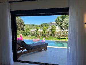 a window with a view of a swimming pool at Villa Danai in Gouvia +65 photos
