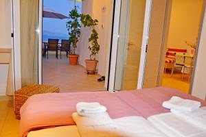 a bedroom with a bed and a view of the ocean at Volissos Holiday Homes in Volissos
