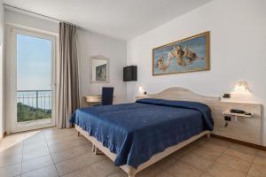 Un pat sau paturi într-o cameră la Hotel Laguna