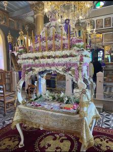 a large altar in a room with flowers at Alexjean cosy apartment close to beach and Dapia in Spetses