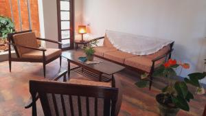 a living room with a couch and chairs and a table at Olive Green Villa in Negombo for Airport Transit in Katunayaka +75 photos