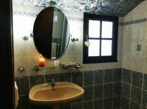 a bathroom with a sink and a mirror and a window at Chez Nicole et Patrick in Chouvigny +9 photos