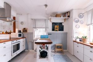 a kitchen with a table with a laptop on it at Villa Virpi in Rovaniemi