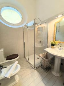 a bathroom with a shower and a toilet and a sink at Klimt's Mill overlooking Port in Malcesine +16 photos