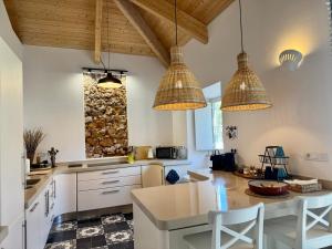a kitchen with white cabinets and a table with chairs at Casa Pompilio in Sagres +72 photos