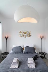 a bedroom with a bed with two towels on it at Rockaine Suites Eclipse in Tinos