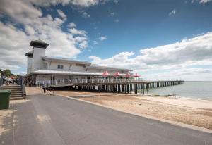 a pier with a building on the beach at Van-Tastic 6 berth static in Felixstowe