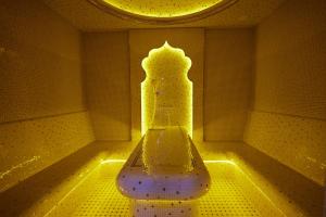 a room with a bench in a room with lights at Noble Samarkand in Samarkand