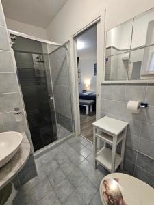 a bathroom with a shower and a sink and a toilet at La Casa di Luna in Riomaggiore