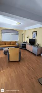 a large living room with a couch and chairs at Gjole Apartments in Lagadin