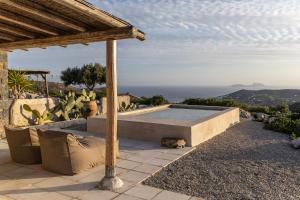 a stone bench sitting on top of a hill at Palazzo Greco Villas in Agia Galini