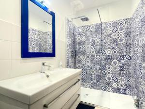 a bathroom with a sink and a shower at CASA AL FARO - Anzio Centro in Anzio