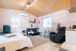 a bedroom with a bed and a living room at Villa Virpi in Rovaniemi