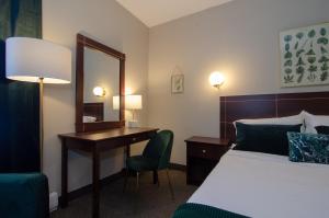 Postel nebo postele na pokoji v ubytování Hotel Dorion