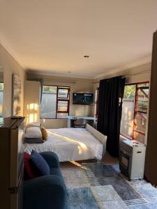 a bedroom with a bed and a couch at OneOnArum in Johannesburg +57 photos