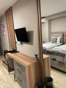 a room with a bedroom with a bed and a mirror at Hotel BLISS Sofia Airport Self Check In in Kazichene