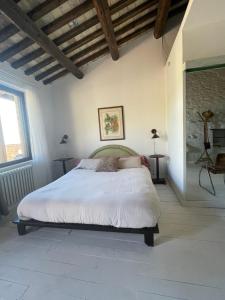 a bedroom with a white bed in a room at Casa Vuscichè - Stanza di Artemisia in Roseto degli Abruzzi +15 photos