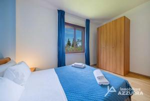 a bedroom with a bed with two towels on it at Darina - Immobiliare Azzurra in Lazise +37 photos