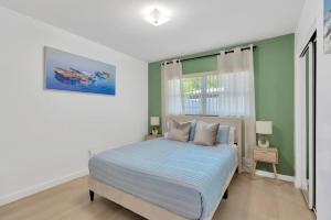 a bedroom with a bed and a window at The Modern Palms few mins from Downtown Tampa Ybor city in Tampa +22 photos