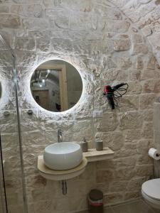 a bathroom with a sink and a mirror at L'arco dei sogni in Ceglie Messapica +3 photos