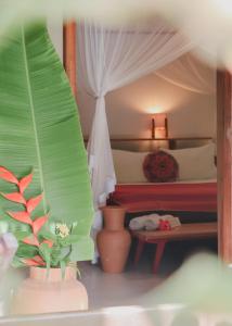 a bedroom with a bed and a potted plant at Na Villa dos Algodões in Marau