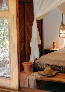 a bedroom with a bed and a table and a window at Na Villa dos Algodões in Marau