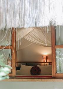 a bedroom with a bed with white curtains at Na Villa dos Algodões in Marau