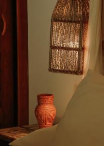 an orange vase sitting on a table next to a window at Na Villa dos Algodões in Marau