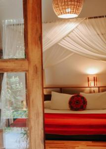 a bedroom with a bed with a flower on it at Na Villa dos Algodões in Marau