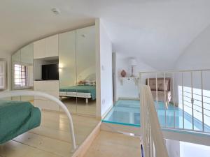 a bedroom with a swimming pool in the middle of a room at Grazy Home - Bright new Apt with Terrace and Jacuzzi in Vico Equense