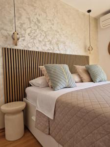 a bedroom with a bed with pillows on it at Blue Diamond Rooms in Zaton
