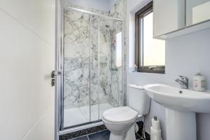 a bathroom with a shower and a toilet and a sink at City Line Apartment 2 in Newtownabbey +16 photos